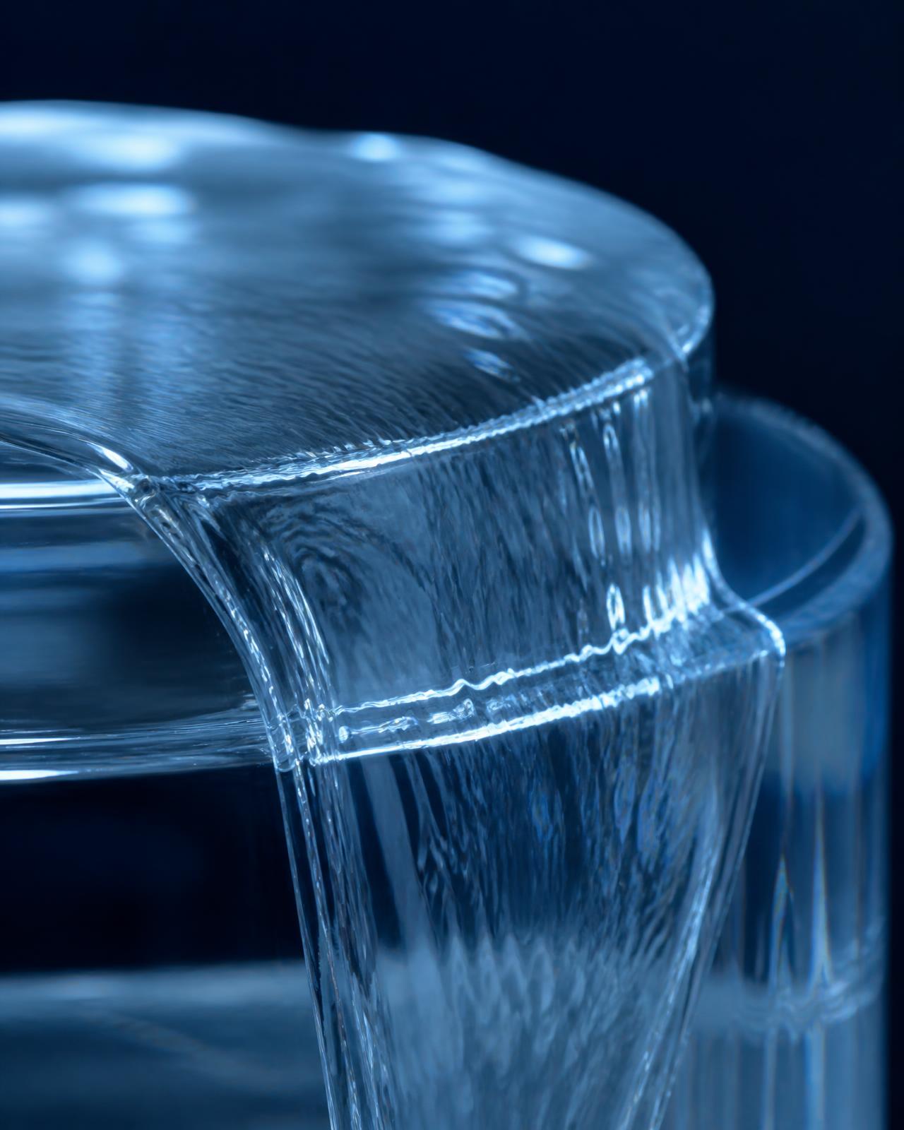 Macro photograph of perfectly clean water flowing over a glass surface